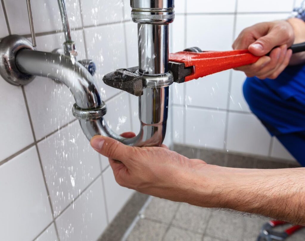Professional plumber in San Diego County, CA repairing residential plumbing systems